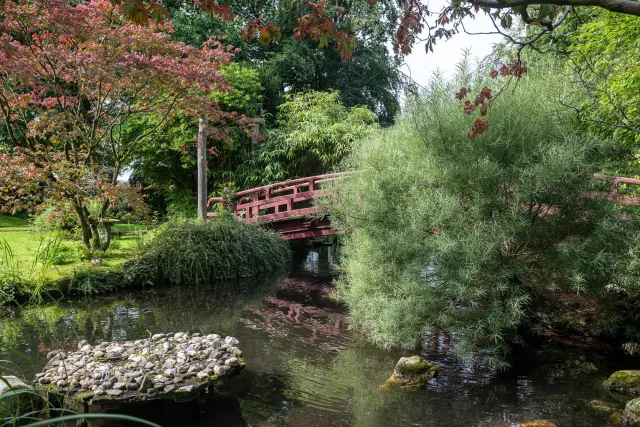 Red bridges over clear waters.